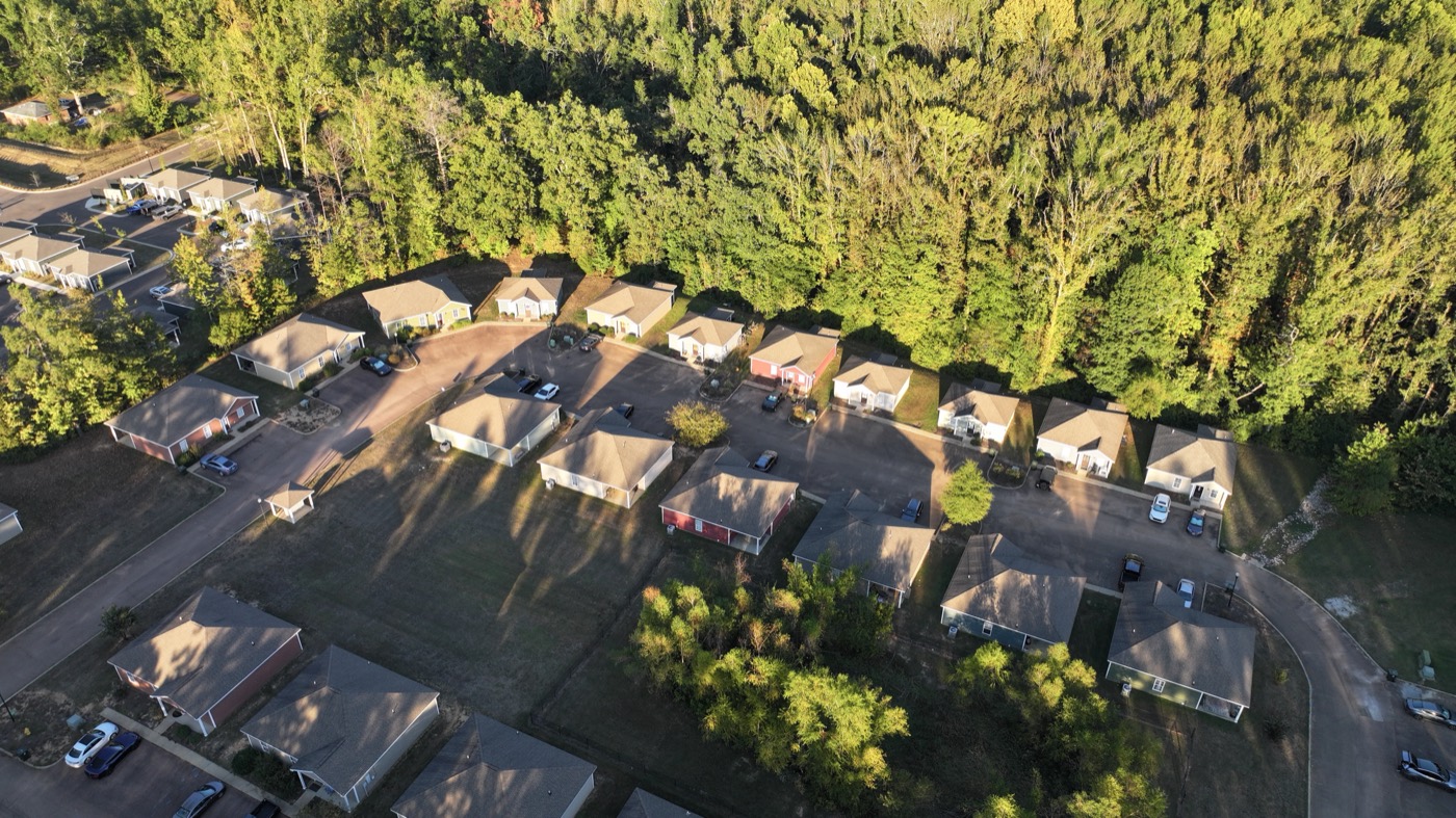 Low drone pass over the Acadia Loop rooftops at golden hour, Oxford MS
