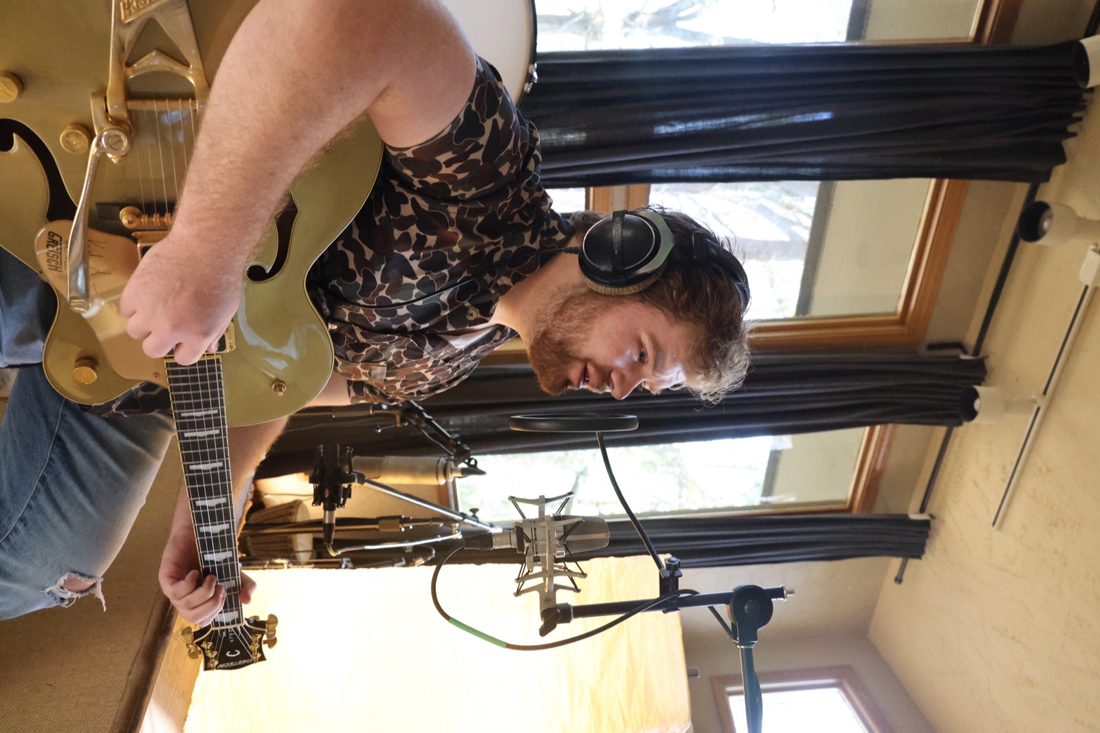 Recording studio session — guitarist at the microphone