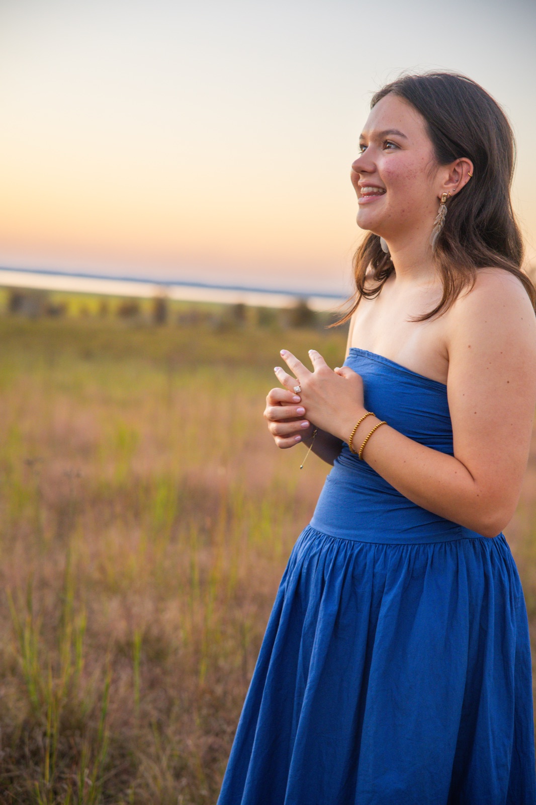 Bride to be laughing in a blue dress at sunset, engagement photography at Sardis Lake