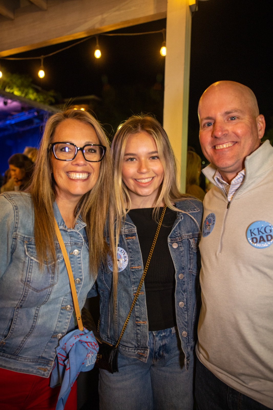 Mom, daughter and dad under string lights at Kappa Kappa Gamma parents weekend at Ole Miss