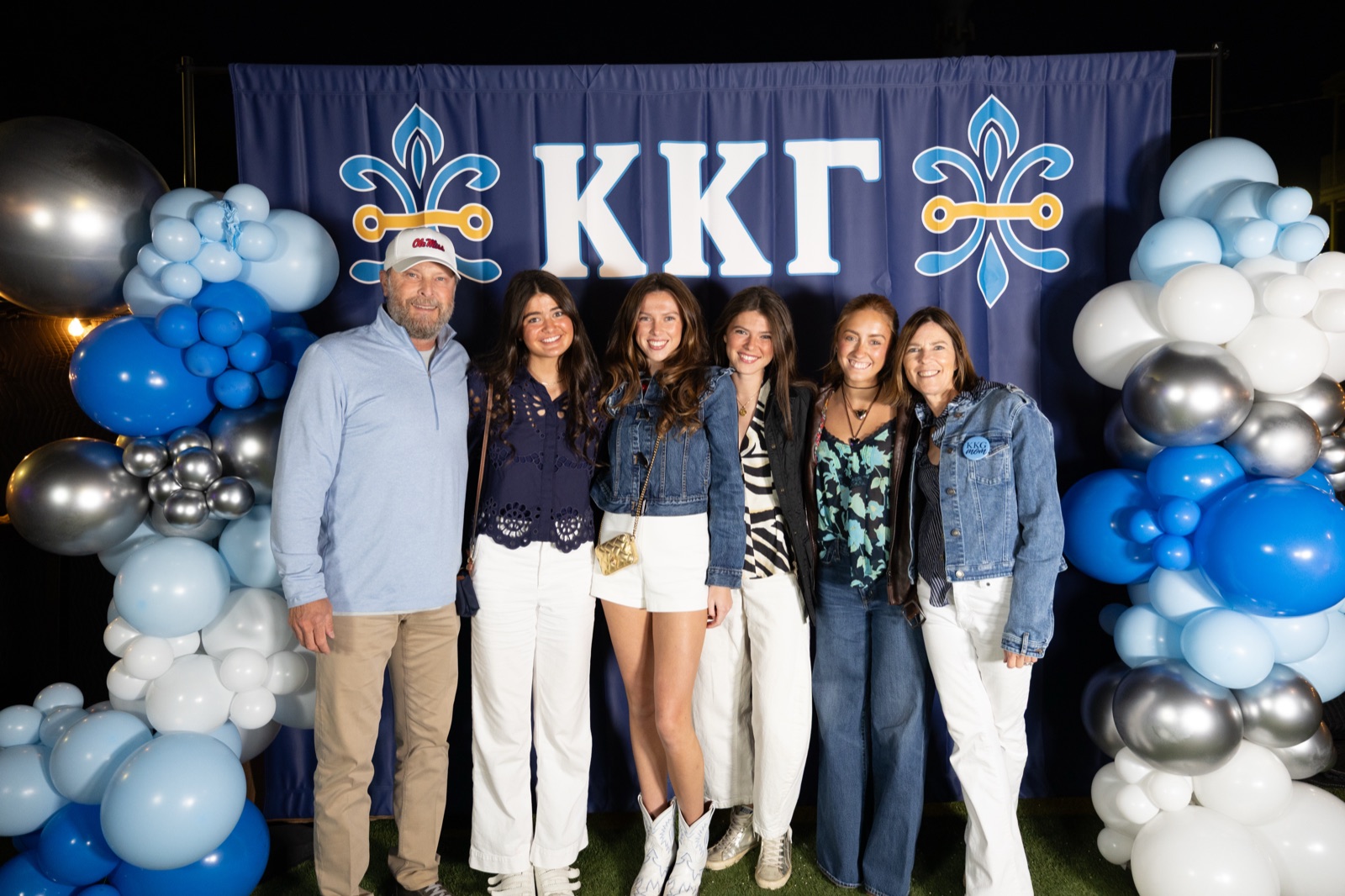 Family group with balloon garland at the Kappa Kappa Gamma parents weekend backdrop at Harrison's, a chapter event photographed by SLP Media