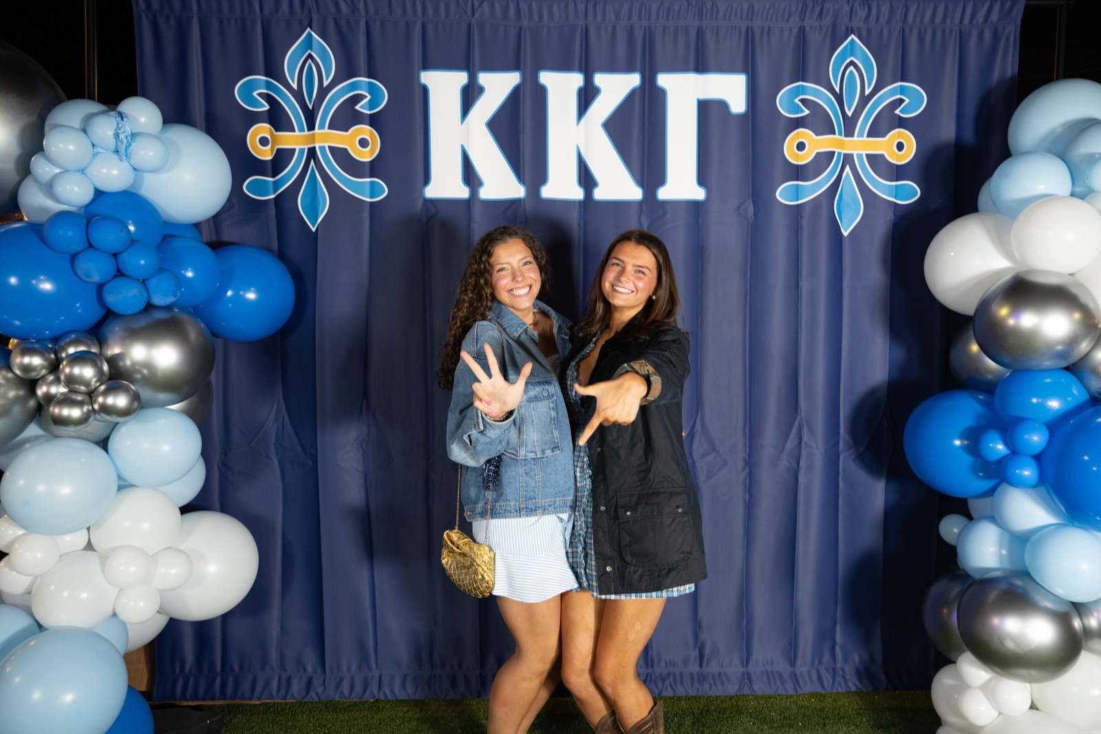 Two Kappa Kappa Gamma sisters at the balloon backdrop during parents weekend at Ole Miss