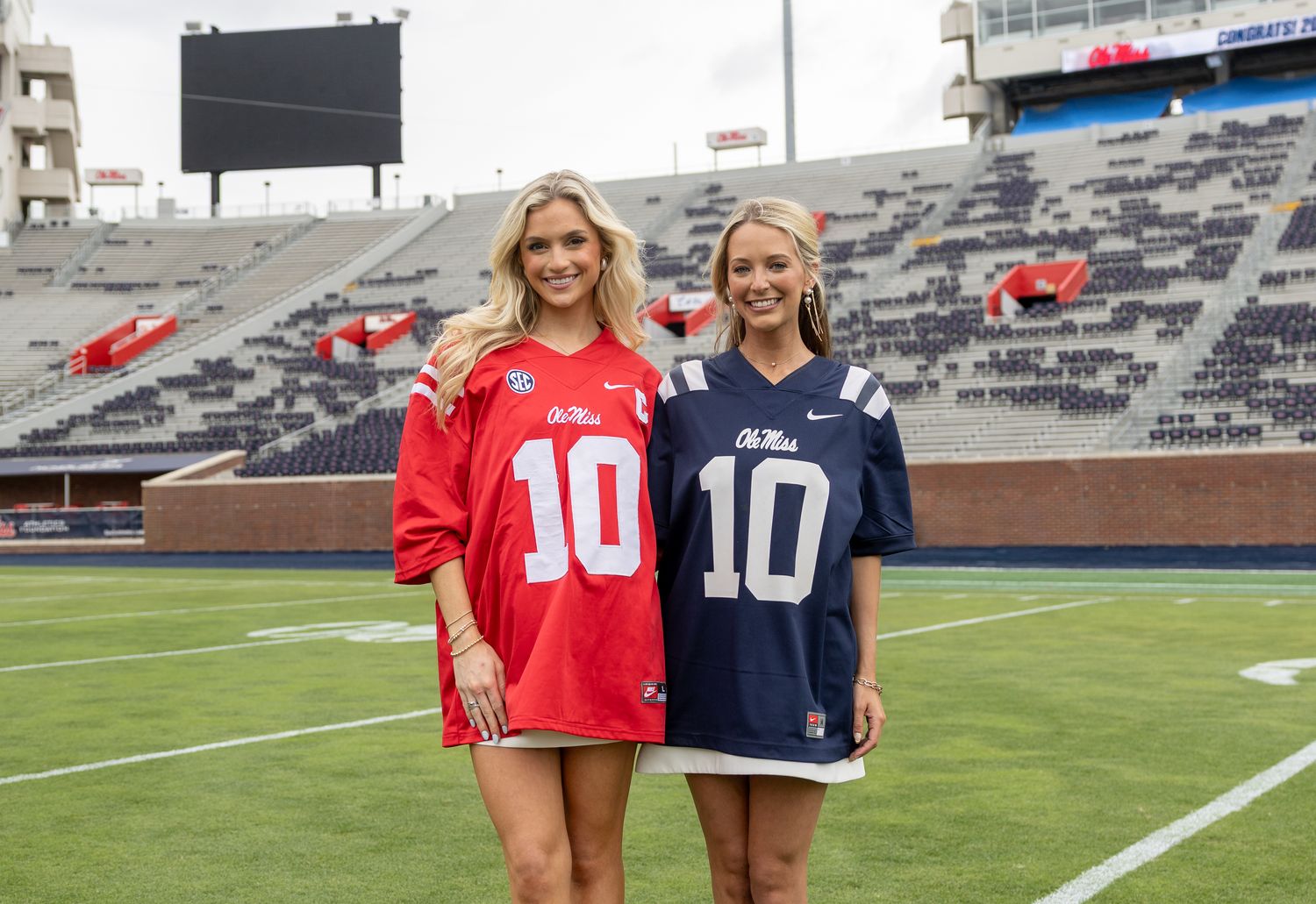 Two Ole Miss graduates in matching number 10 jerseys on the field at Vaught-Hemingway Stadium