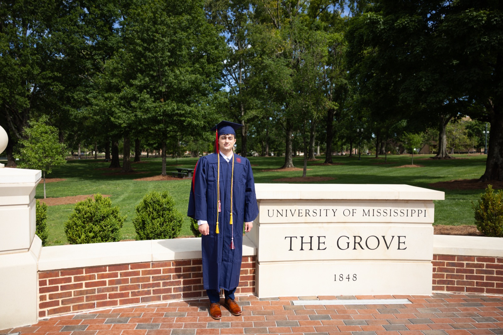 Graduate at The Grove sign, University of Mississippi