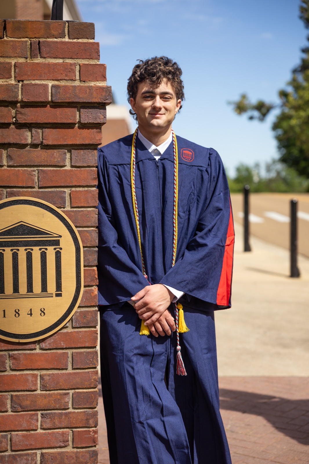Graduation portrait by the university seal